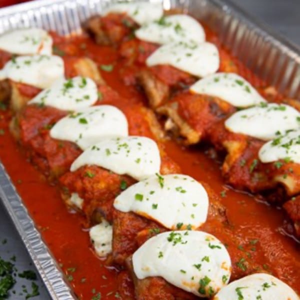 A catering tray of Pino's La Forchetta's baked ziti with fresh mozzarella and marinara sauce.